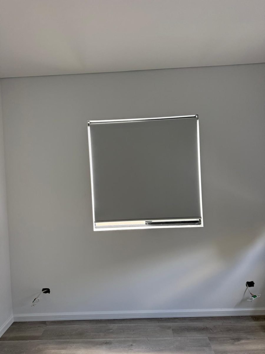 Roller blind mounted over a small window in a Perth home