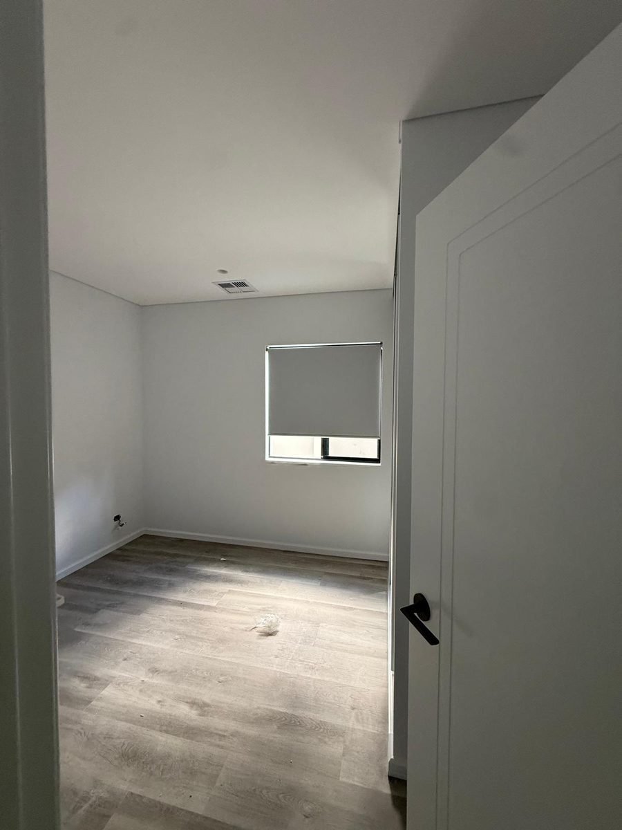 Roller blind installation in a Perth home viewed from the hallway