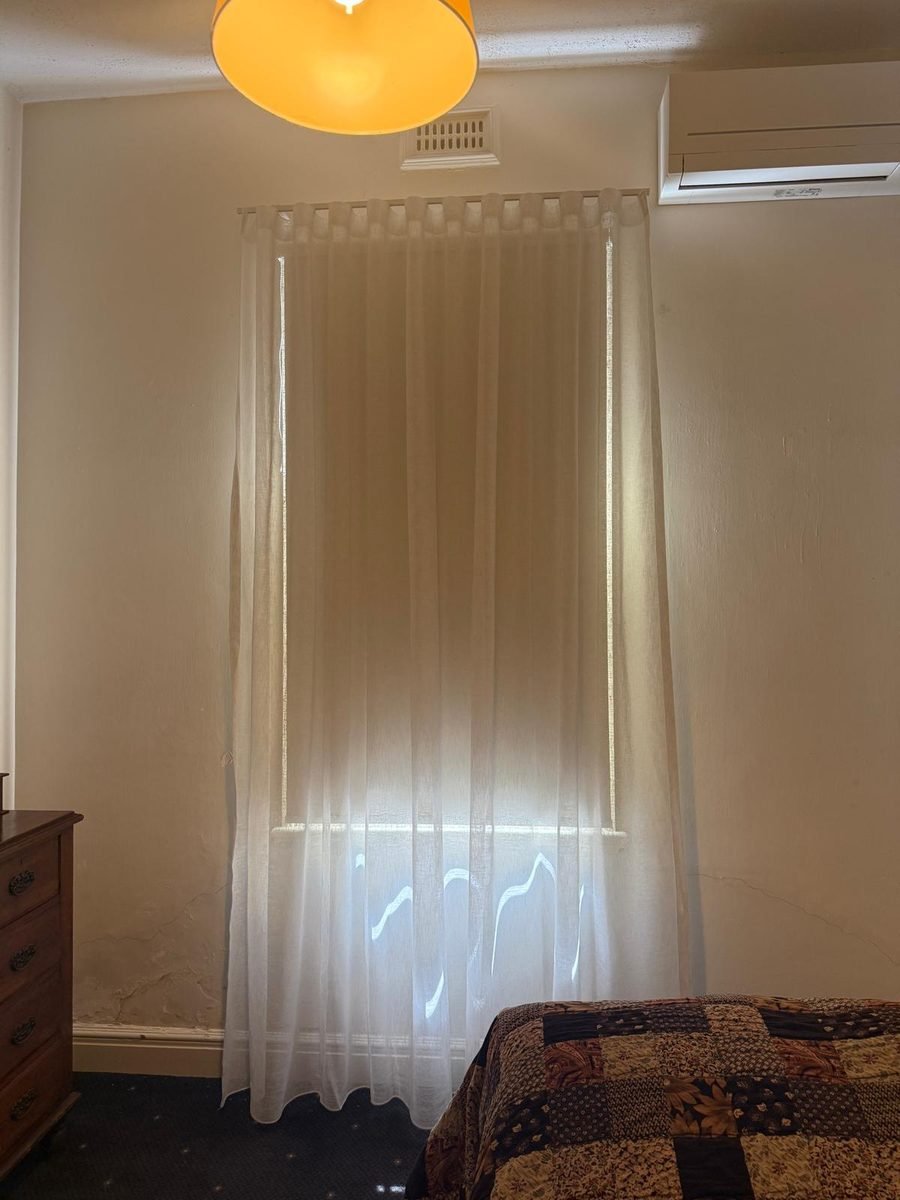 Sheer curtains softening daylight in a Perth bedroom