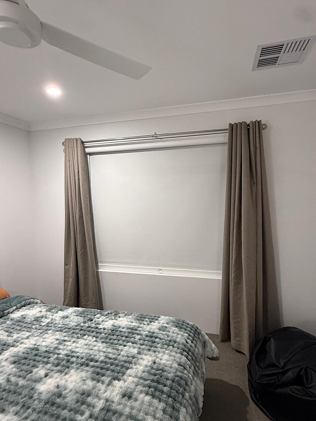 Layered curtains and roller blind combination in the adjoining bedroom