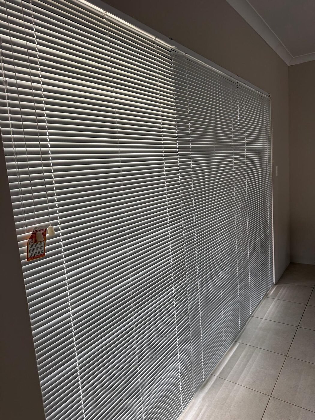 Aluminium venetian blinds fitted to a hallway sliding door in a Perth home